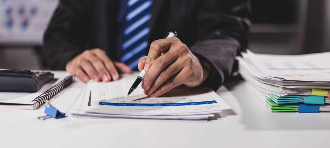 Businessman working on financial documents in the office, accounting, auditing and business investment budget planning.